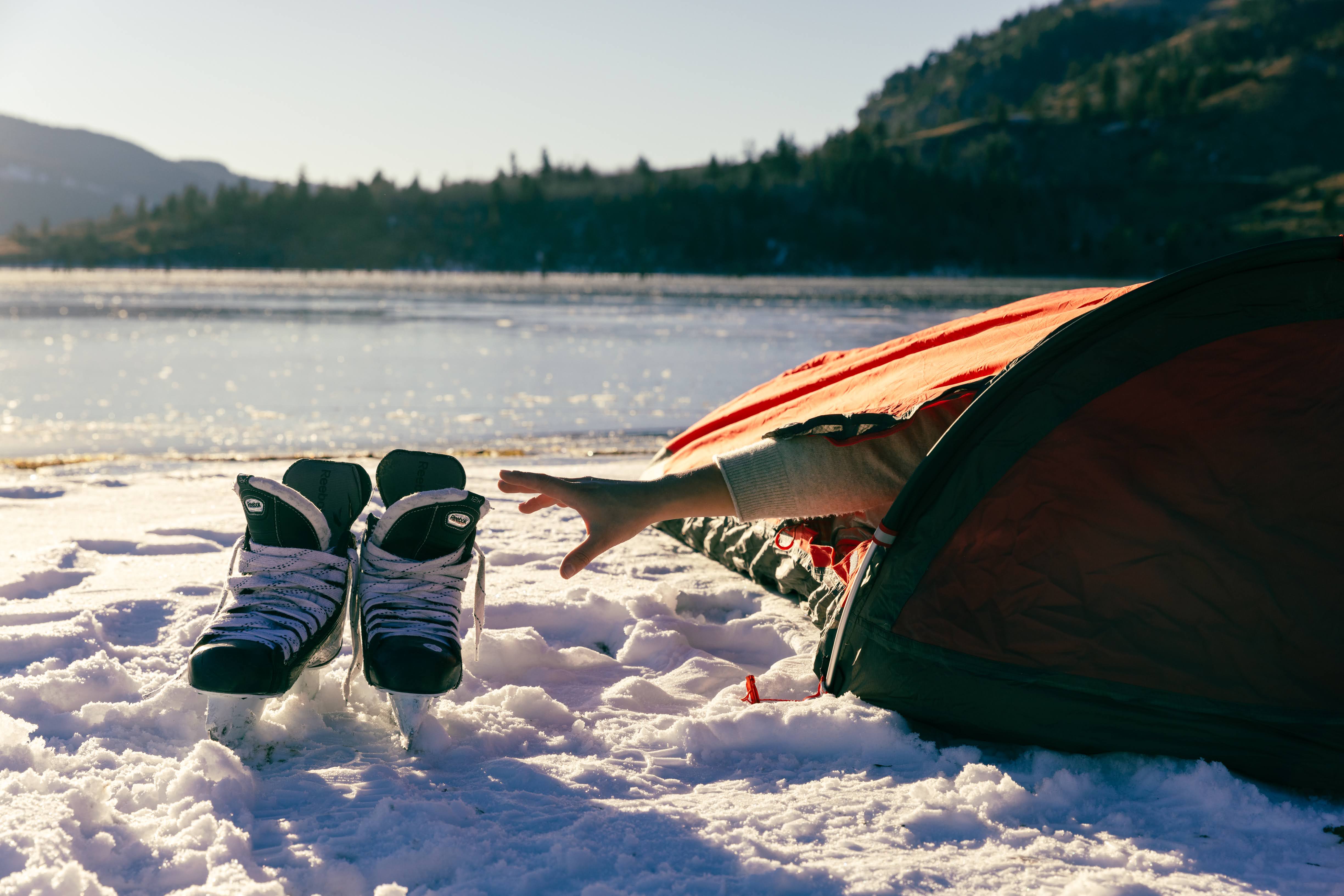 Reaching for ice skates from the tent