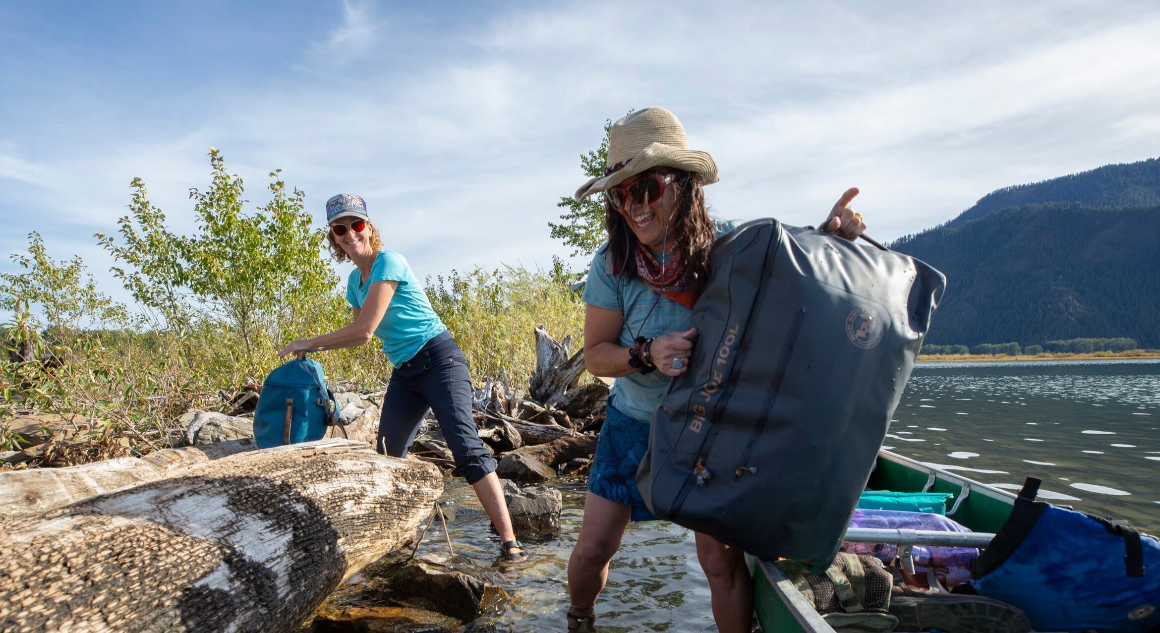 unloading big joe gear duffels from a canoe