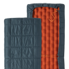 Two sections of a sleeping bag, one blue quilted and one orange inflatable, on a white background.