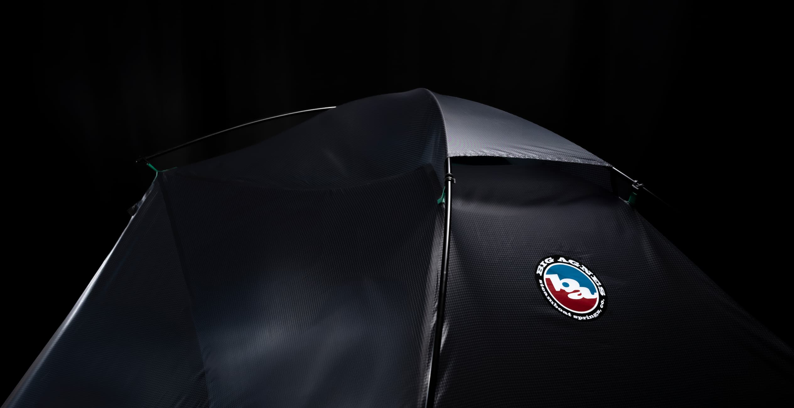 Black tent with a logo on a black background