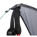 Close-up of the Big Agnes String Ridge VST 1.5, with a trekking pole supporting the tent’s black and gray fabric corner, black strap, and green guyline with a plastic tensioner in this ultralight shelter setup.