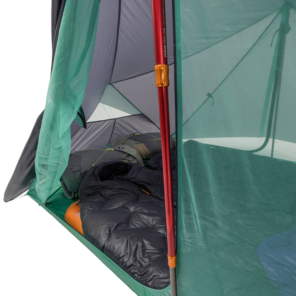 Camping tent with a sleeping bag inside, showing the interior setup.