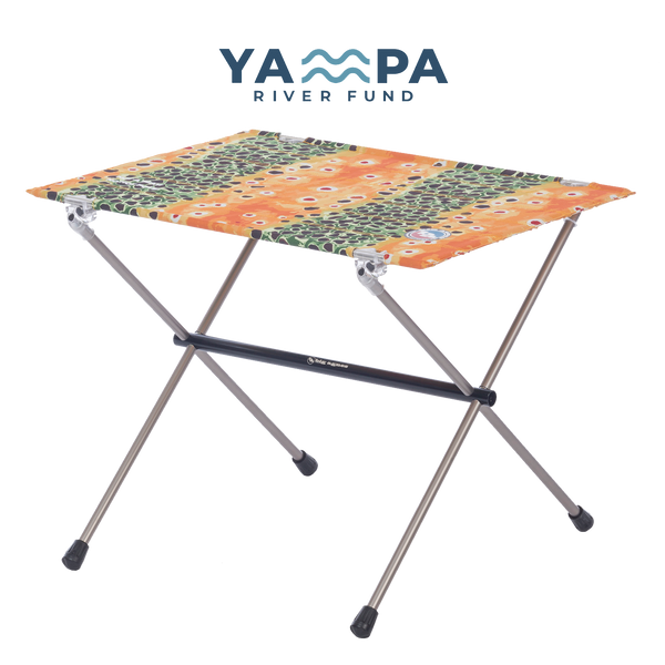 Portable folding table with colorful pattern on a white background, featuring the Yampa River Fund logo.