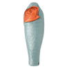 The Big Agnes Women's Greystone 30° sleeping bag in light blue, featuring DownTek insulation, stands upright against a white background. Its mummy-style hood is slightly open, showing the bright orange interior lining.