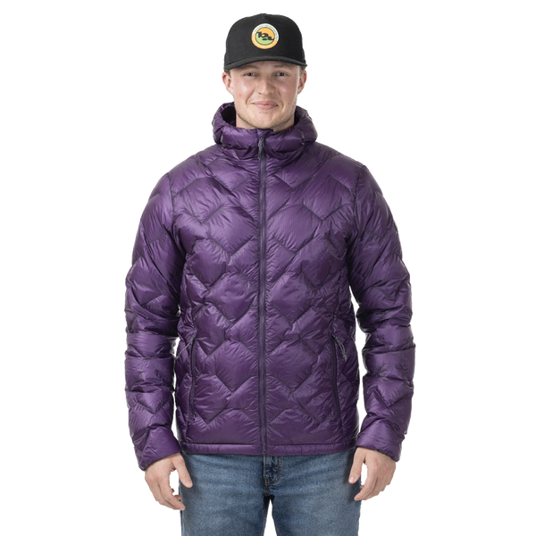 Person wearing a purple quilted jacket and black cap on a white background