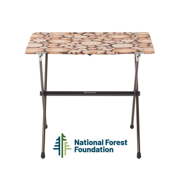 Portable folding table with a patterned top on a white background, featuring the National Forest Foundation logo.