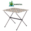 Portable folding table with patterned top on a white background, featuring Yampatika brand logo.